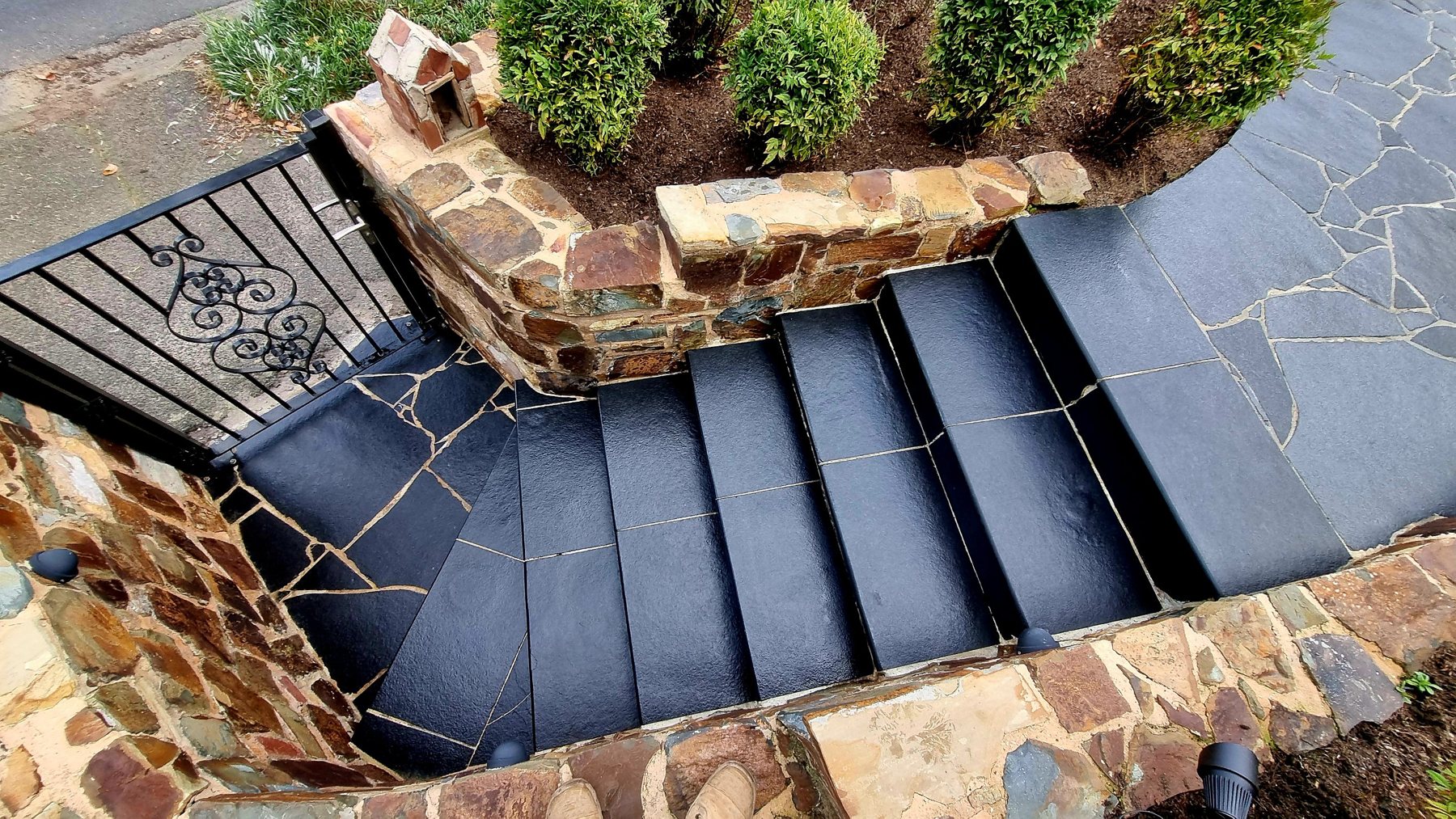 Black stone steps and natural stone walls seen from above