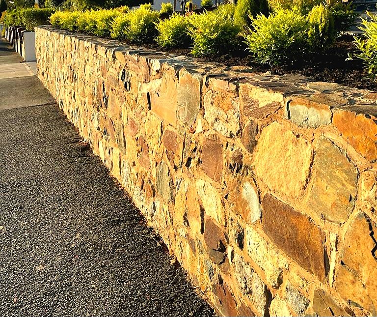 Natural stone retaining wall in golden evening light