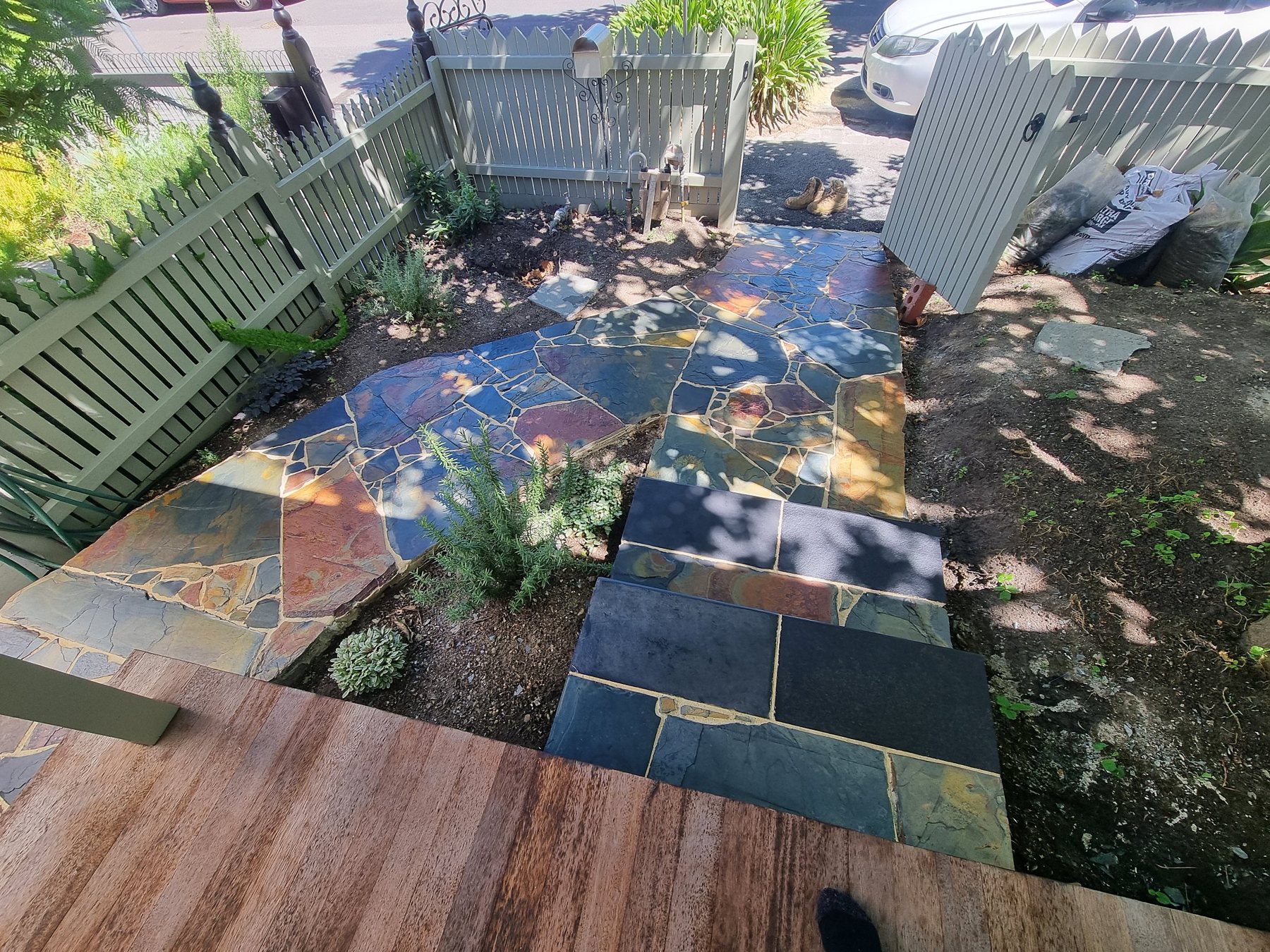 Slate crazy paving path and steps seen from the verandah