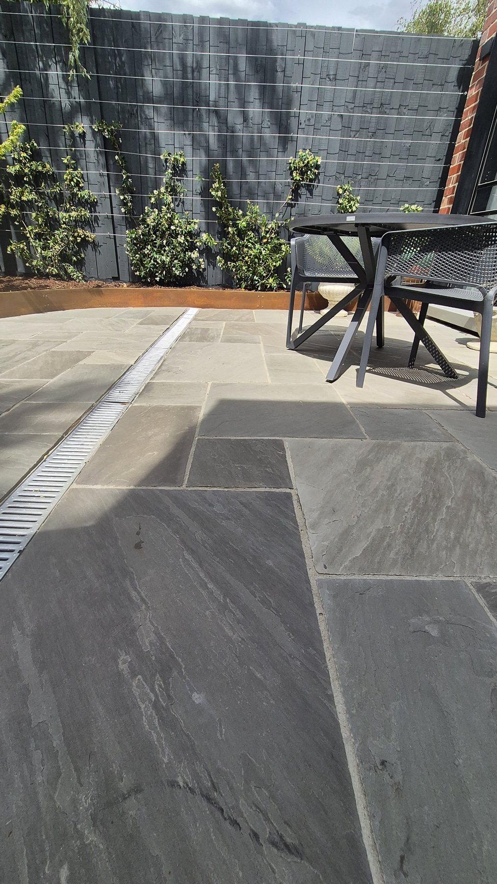 Stone paving and strip drain beside the dining table