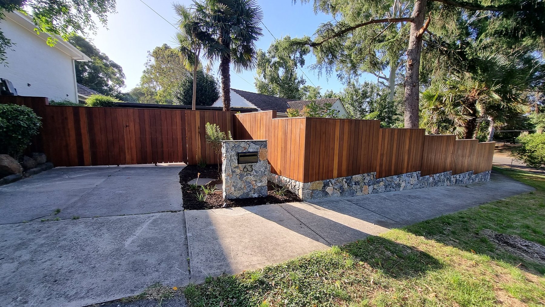 Front fence, gate and stone letterbox pillar with new planting