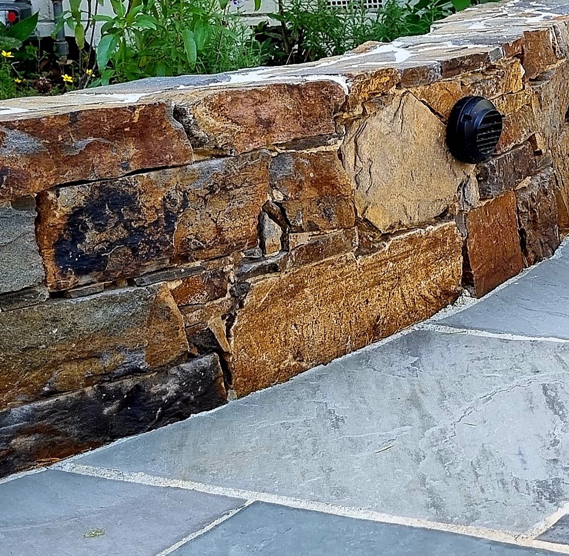 Close view of the stacked stone wall with a recessed light