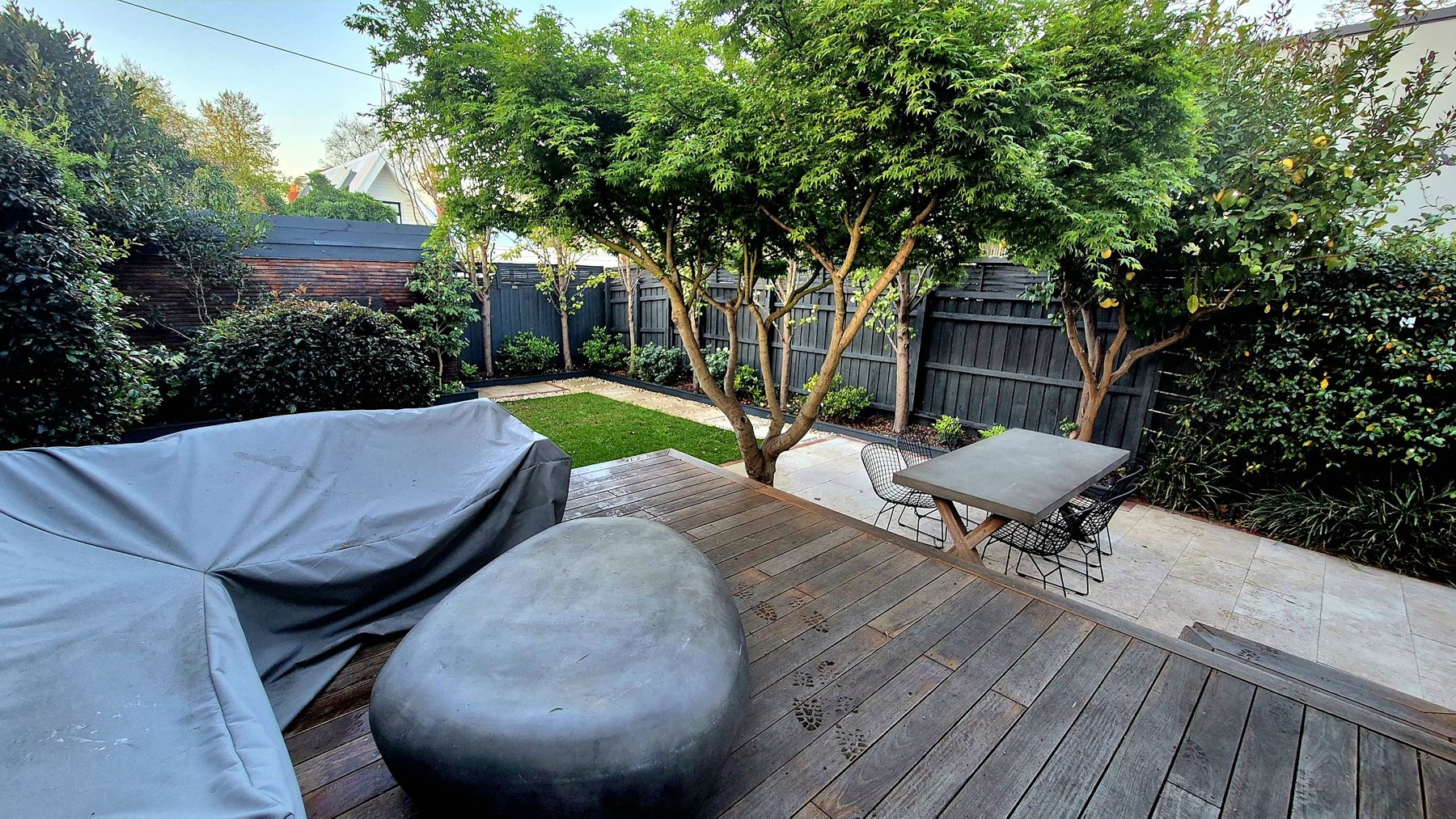 From the deck down to the dining terrace, lawn and fence-line planting