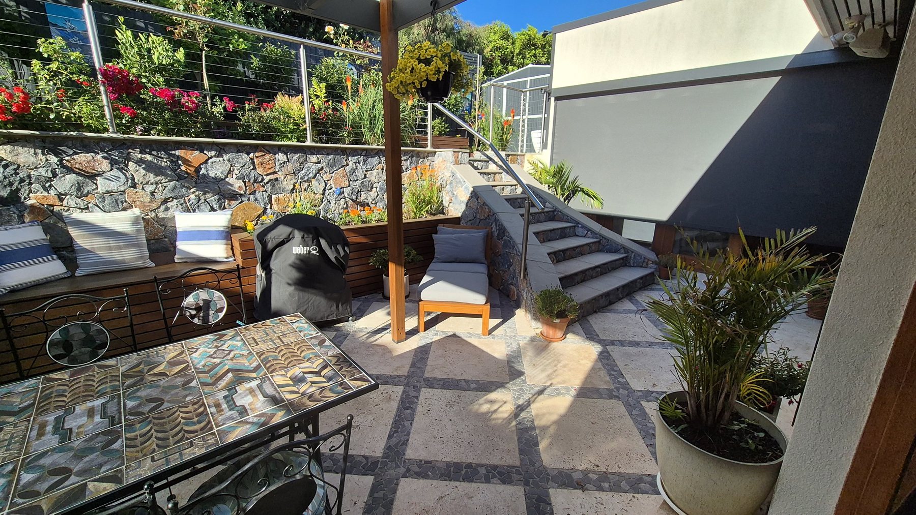 Courtyard planter benches beside the stone-clad stairs