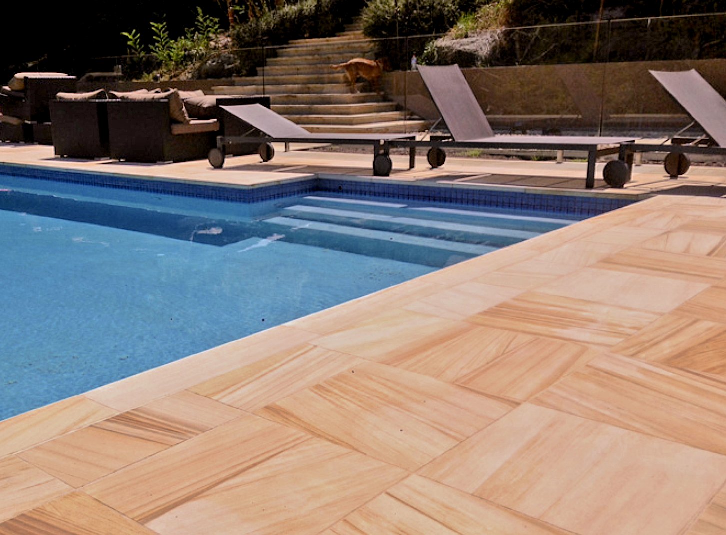 Pool with stone paving, steps and loungers