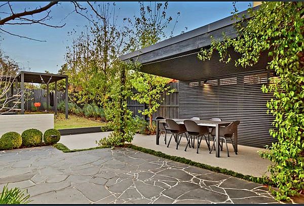 Crazy paving courtyard leading to the covered dining pavilion