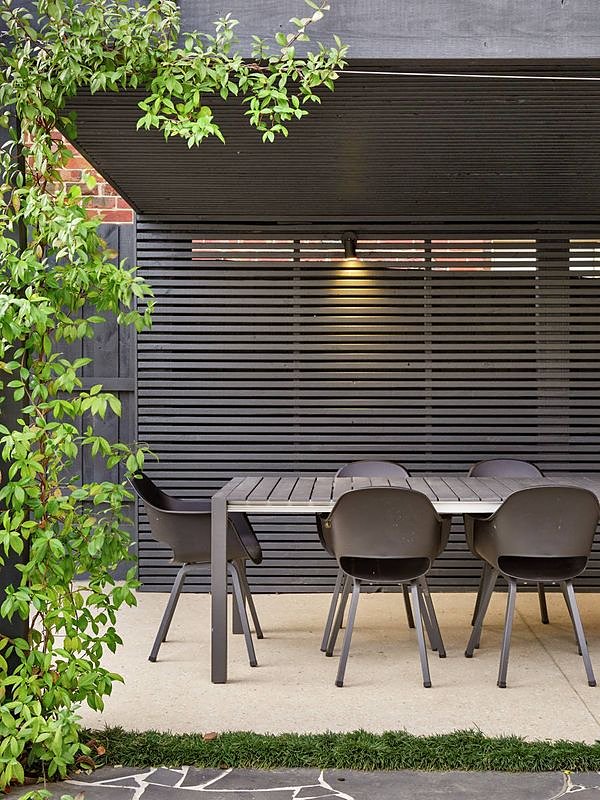 Black timber slat screen and pavilion over the outdoor dining area