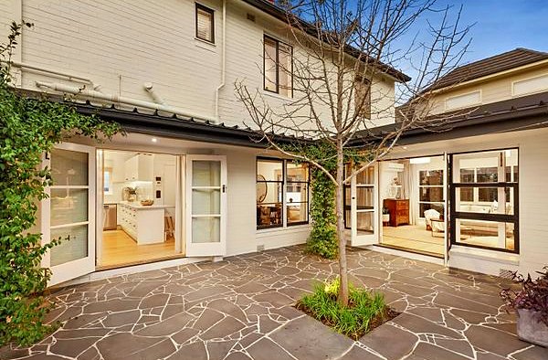 Crazy paving courtyard around a feature tree, opening off the house